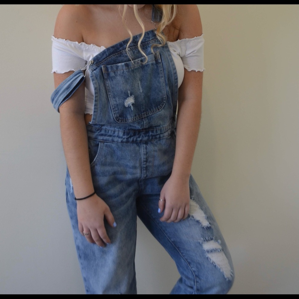 Distressed denim overalls
